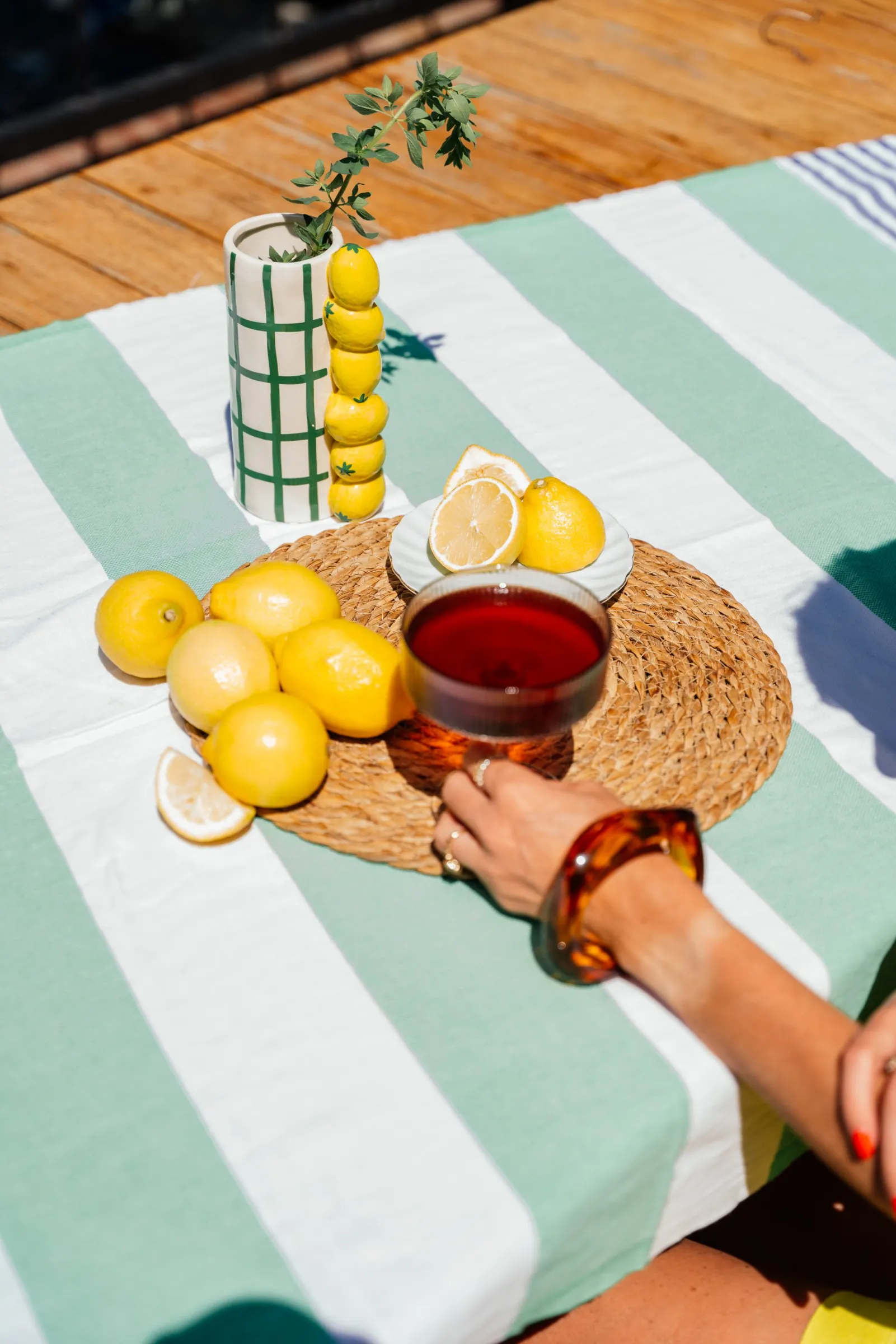 Lemons and a glass of iced tea on a striped table